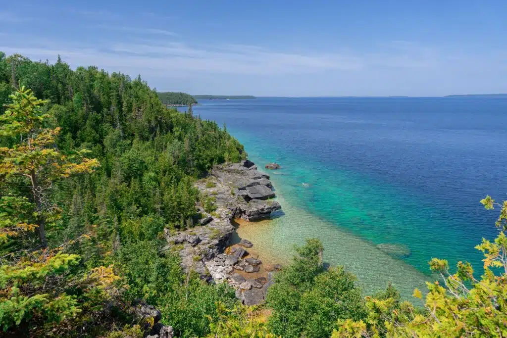 Crystal-clear lake waters and rocky terrain in Tobermory, Ontario, a perfect destination for outdoor lovers.